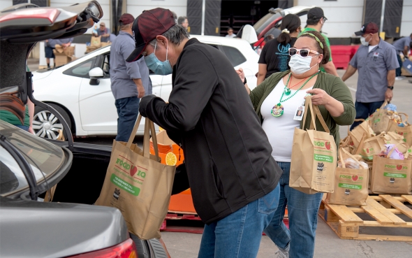 two people working at a foodbank